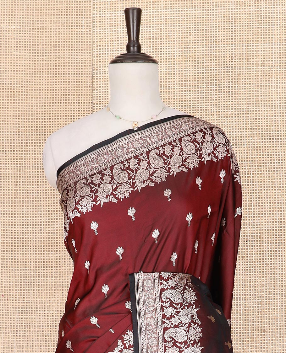 Maroon buttas mushru silk saree, self-border of floral-paisley creeper designs, and paisley design pallu