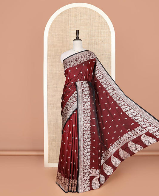 Maroon buttas mushru silk saree, self-border of floral-paisley creeper designs, and paisley design pallu