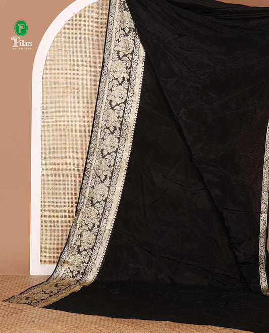 Black plain crepe saree, zari border steeped with rose floral designs, plain pallu & blouse of zari polka dots