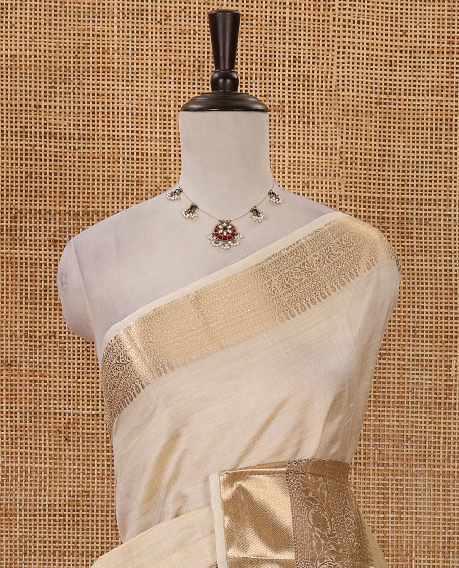 Cream plain tussar saree, traditional zari design border, pallu of zari stripes & matching traditional motif border blouse
