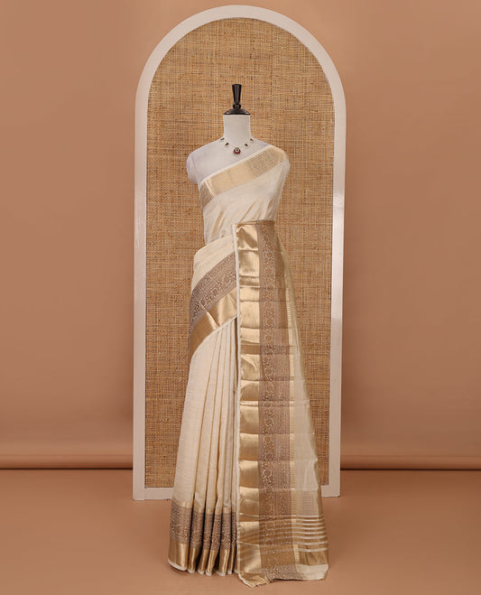 Cream plain tussar saree, traditional zari design border, pallu of zari stripes & matching traditional motif border blouse