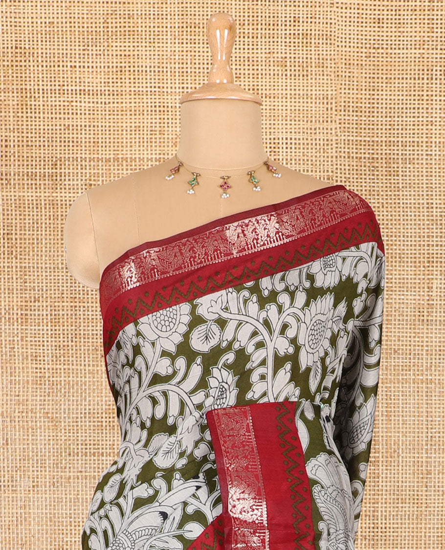 Olive kalamkari floral vine and peacock printed muslin cotton saree, contrast zari border, kalamkari peacock printed pallu, and a contrast coin buttas printed blouse