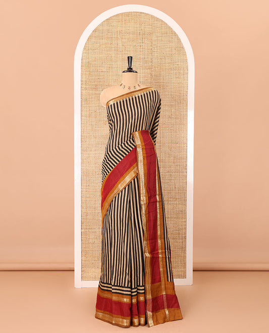 Black vertically striped muslin silk saree, contrast zari rettai pettu border, kalamkari floral vine printed pallu, and a contrast plain blouse