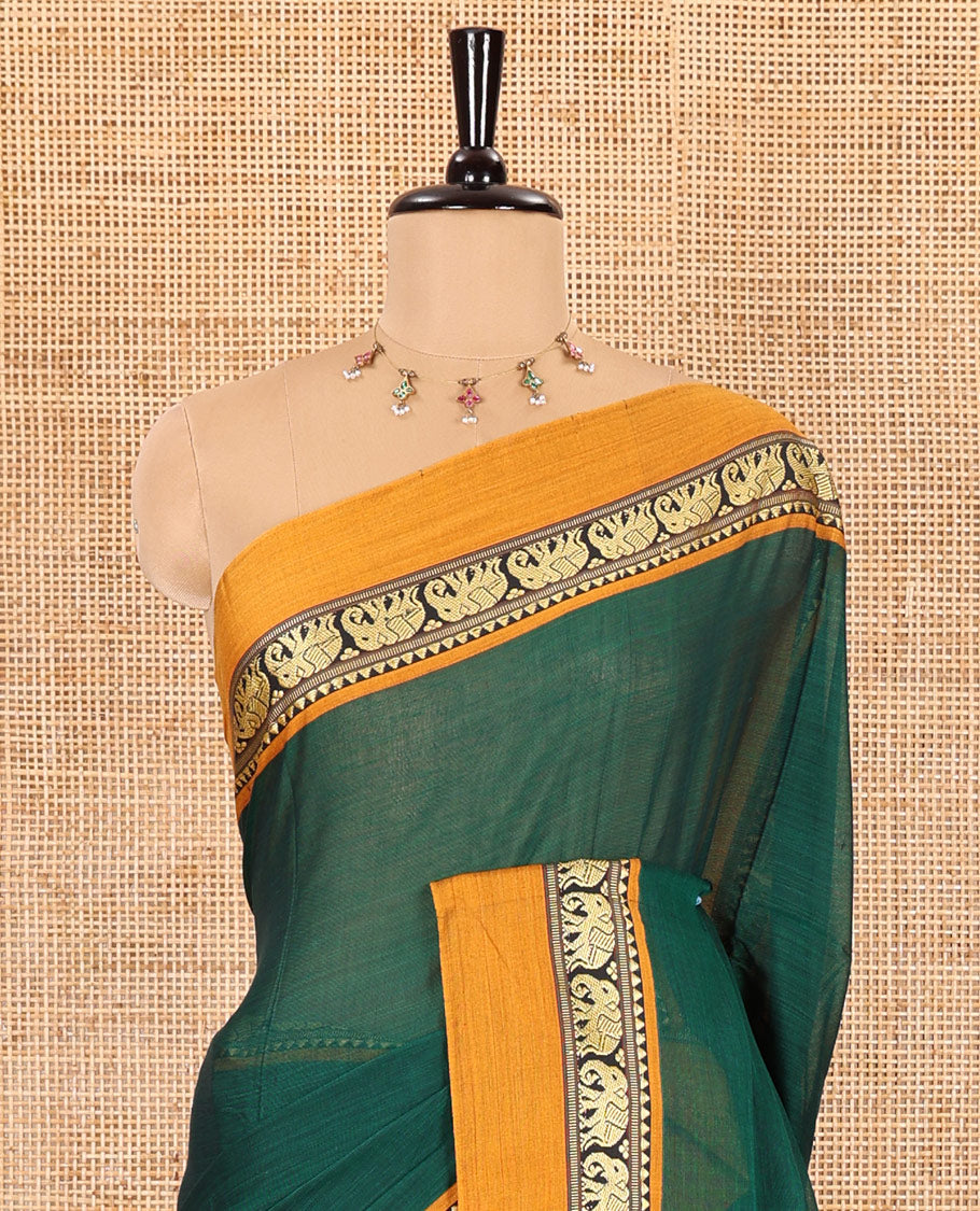 Green plain mercerised cotton saree, contrast kal erangina thread border of elephant motifs, striped pallu, and a matching blouse