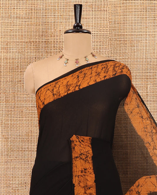 Black and mustard plain georgette saree, batik printed border, batik printed checked pallu, and a matching blouse