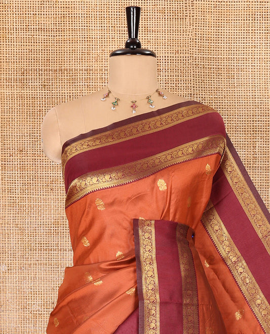 Orange zari buttas kanchi soft silk saree, contrast manga and peacock motifs woven rettai pettu border, ogee patterned pallu, and a zari design blouse