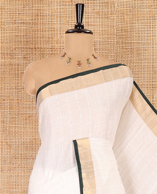 White and green sequins striped Linen cotton saree, contrast zari sequins striped border, striped pallu, and a contrast plain blouse