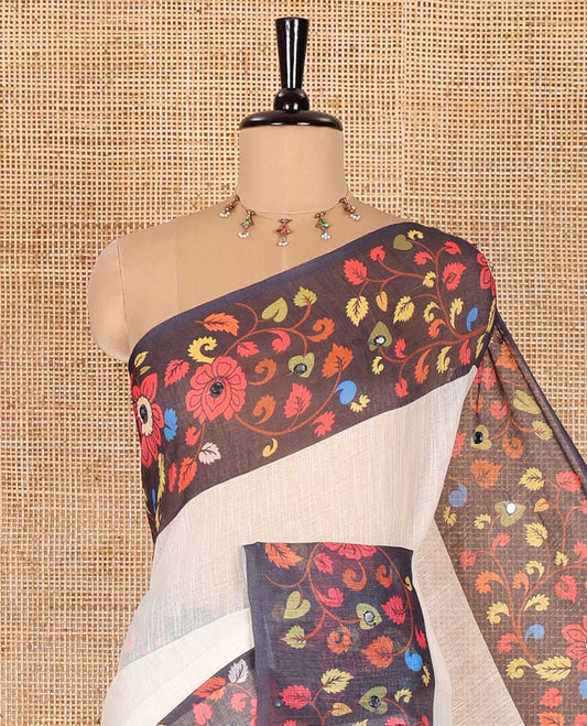 Cream plain linen cotton saree, contrast colorful floral vine printed border with mirror work, peacock printed pallu, and a contrast floral vine printed blouse