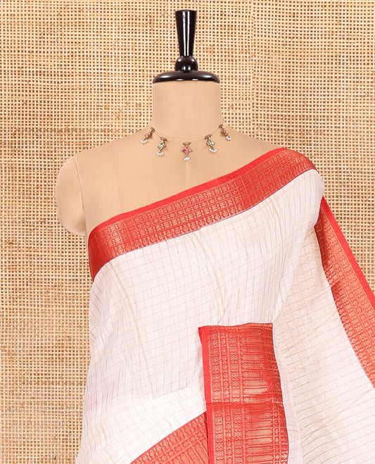 White zari checked dola silk saree, contrast traditional zari border, kalamkari floral-peacock printed pallu, and a kalamkari printed blouse