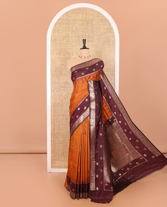 Rust Orange Soft Silk Saree Gracefully Embellished with Zari Buttas Woven All Over Its Body, Highlighted with a Contrast Traditional Zari Border Featuring Floral Creeper Design, Zari-Rich Jaal Pallu, and Paired with a Contrast Zari Design Blouse