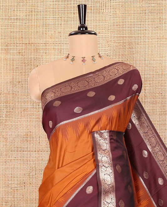 Rust Orange Soft Silk Saree Gracefully Embellished with Zari Buttas Woven All Over Its Body, Highlighted with a Contrast Traditional Zari Border Featuring Floral Creeper Design, Zari-Rich Jaal Pallu, and Paired with a Contrast Zari Design Blouse