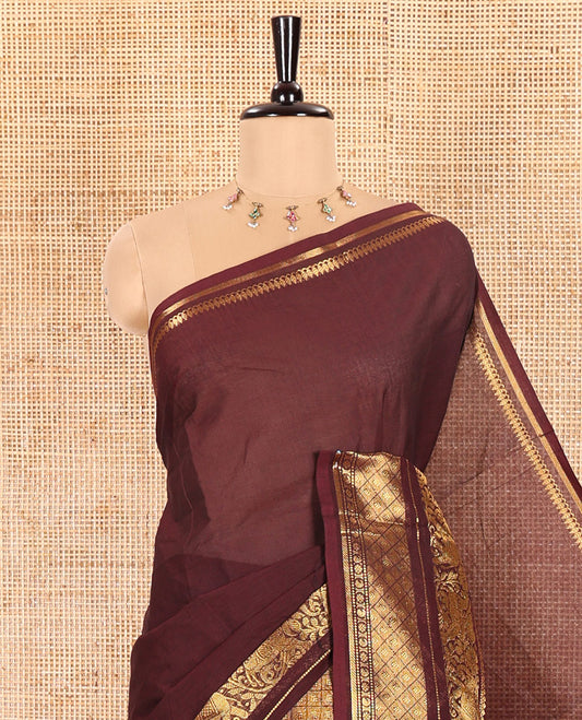 Coffee Brown Plain Chettinad Cotton Saree Adorned with a Gleaming Zari Varisai Pettu Border Featuring Horse, Elephant, and Jaal Designs, Subtly Striped Pallu, and Paired with a Matching Blouse