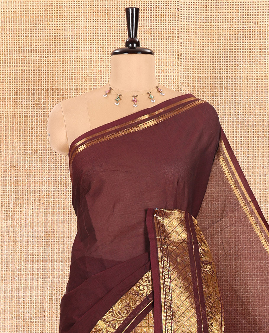 Coffee Brown Plain Chettinad Cotton Saree Adorned with a Gleaming Zari Varisai Pettu Border Featuring Horse, Elephant, and Jaal Designs, Subtly Striped Pallu, and Paired with a Matching Blouse