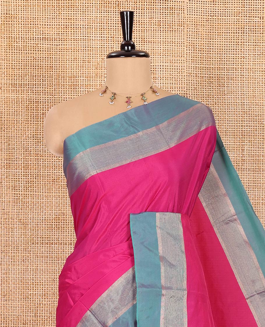 Rani Pink Plain Semi-Soft Silk Saree, Complemented by a Contrast Silver Zari Striped Border, Sparsely Striped Pallu, and Paired with a Matching Blouse