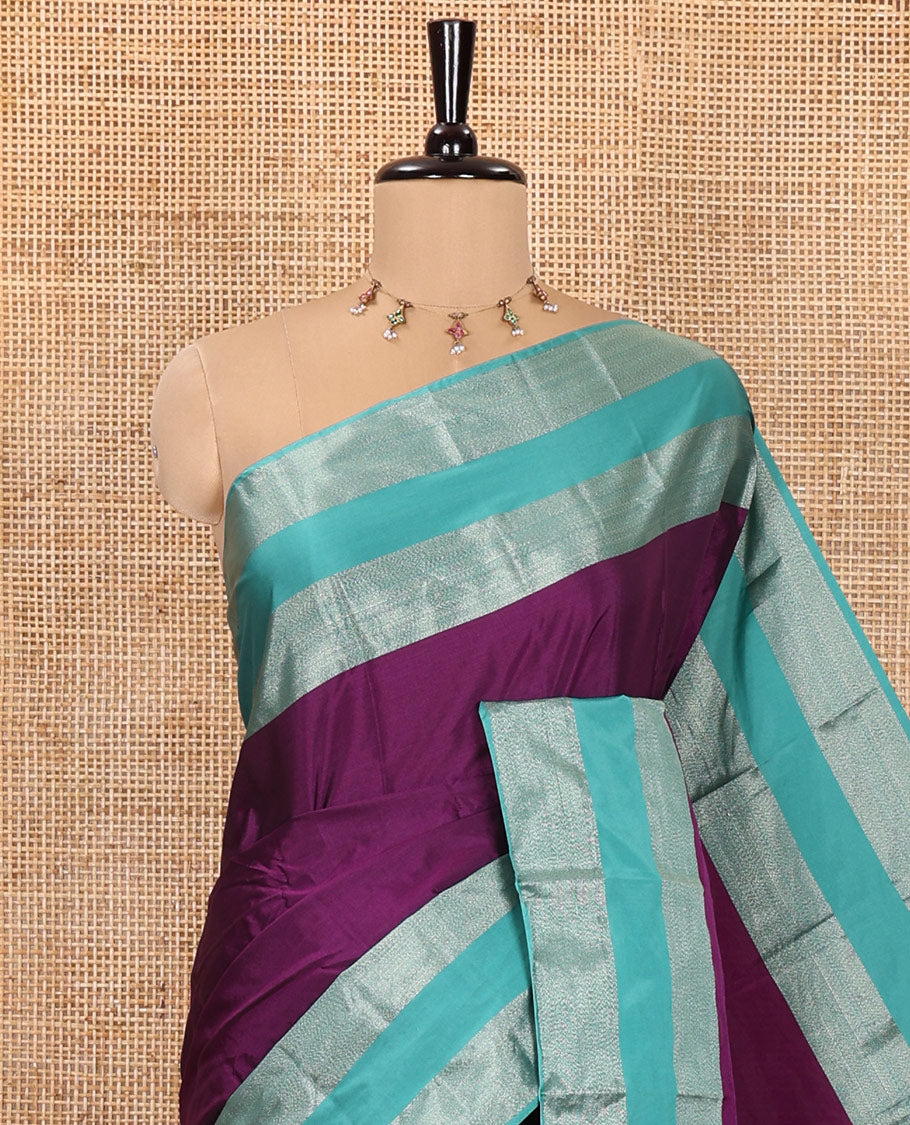 Purple Plain Semi-Soft Silk Saree, Complemented by a Contrast Zari Woven Border, Pallu Features Sparse Stripes, and Paired with a Matching Blouse