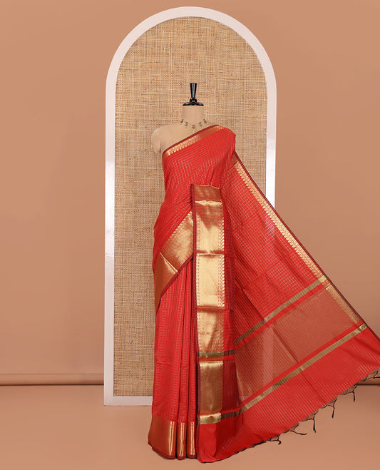 Red Semi-Katan Silk Saree, Embellished with Golden Zari Checks on Its Body, Highlighted by a Traditional Zari Border of Paisley and Rudraksham Designs, Gleaming Pallu, and Paired with a Matching Blouse