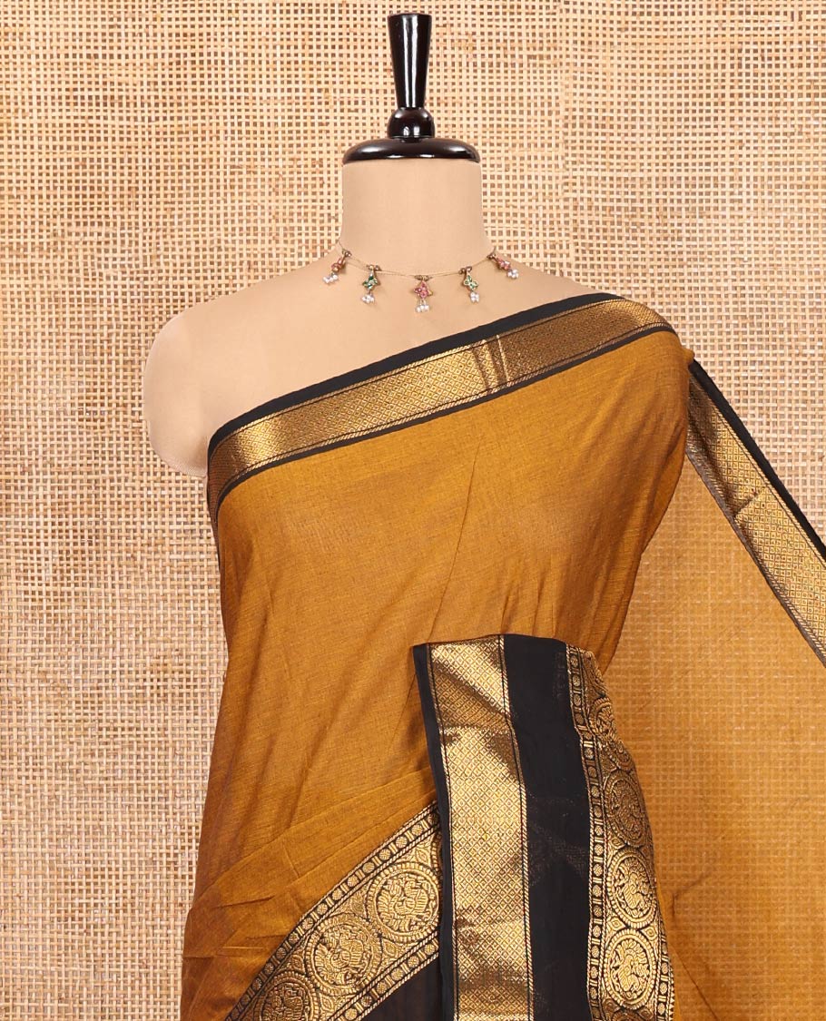 Gold Plain Chettinad Cotton Saree, Complemented by a Contrast Rettai Pettu Traditional Border of Round Peacock Designs, Striped Pallu, and Paired with a Matching Blouse