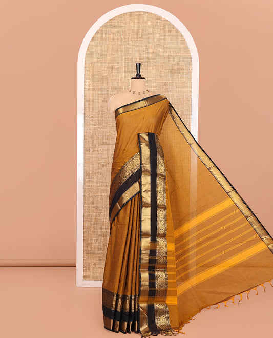 Gold Plain Chettinad Cotton Saree, Complemented by a Contrast Rettai Pettu Traditional Border of Round Peacock Designs, Striped Pallu, and Paired with a Matching Blouse