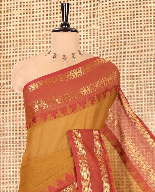 Mustard Chettinad Cotton Saree, Subtly Sparkled with Paisley Buttas All Over Its Body, Complemented by a Contrast Temple Rettai Pettu Traditional Zari Design Border, Pallu of Stripes and Buttas, and Paired with a Matching Blouse