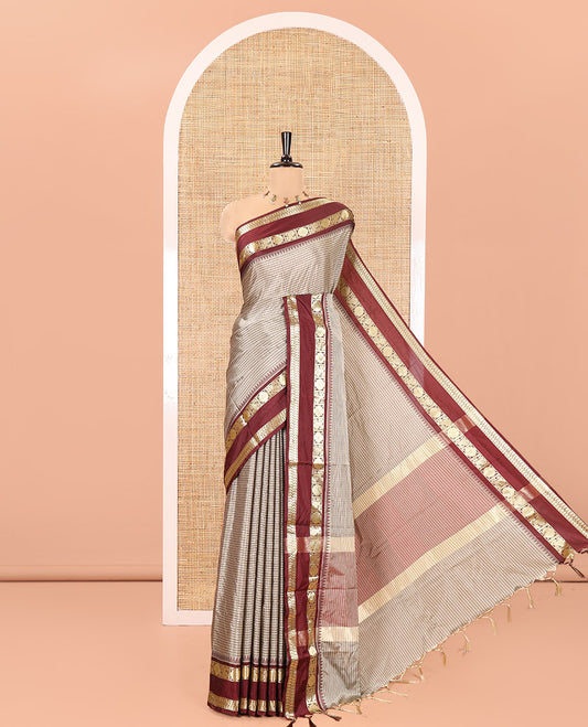 Grey Soft Silk Saree, Subtly Sparkled With Vintage Checks On Its Body, Complemented by Contrast Rettai Pettu Border of Paisleys and Rudraksham Designs, Subtle Pallu and Paired with a Matching Blouse