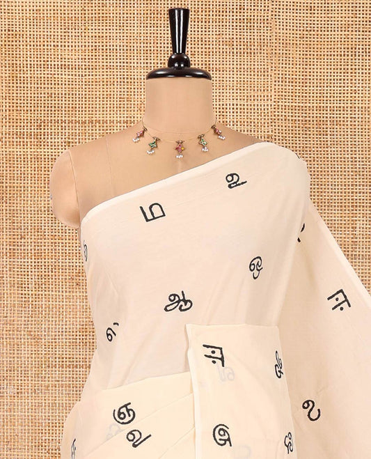 Borderless Cream South Cotton Saree, Elevated with Tamil Letters Printed on Its Body, a Self-Pallu, and Comes with a Matching Blouse, and a Contrast Printed Blouse