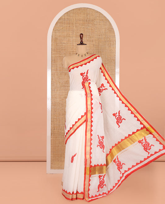 Cream-Red Kerala Cotton Saree, Elevated with Figurine Patch Applique Embroidery, a Contrast Temple Border, and Matching Blouse