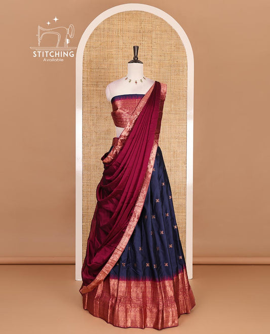 Dark blue taffeta silk half saree, floral zari buttas with contrast green traditional zari border, matching zari blouse, and contrast plain zari border dhavani