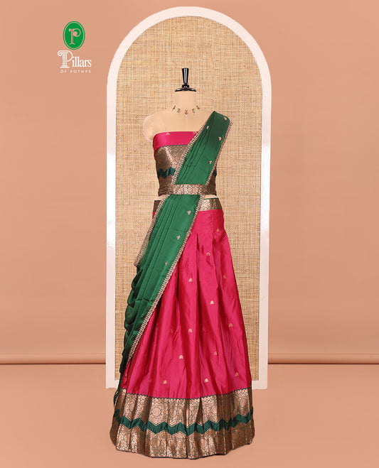 Pink and Green Semi-Banarasi Half-Saree Elevated with Zari Buttas on Its Skirt, Complemented by Contrast Traditional Zari Border of Chakram Designs, Paired with a Matching Blouse, and a Satin Georgette Embroidered Scallop Dhavani
