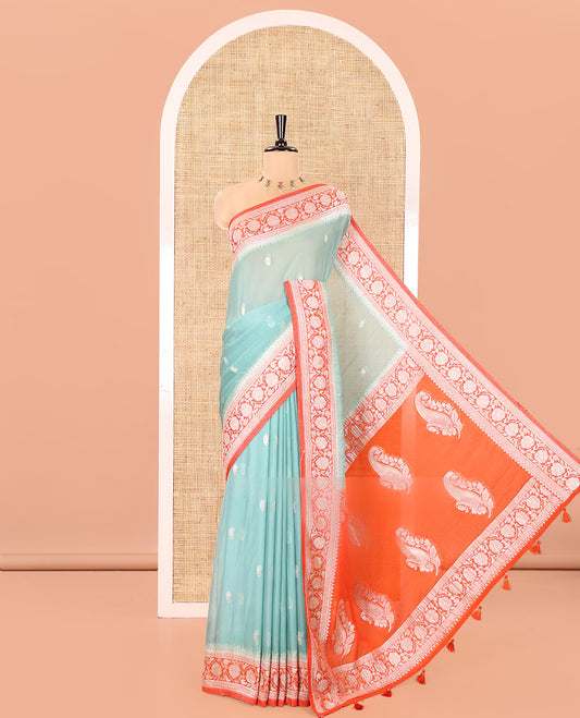 Turquoise Banaras Fancy Georgette Saree, Ornamented with Zari Buttas All Over Its Body, Complemented by a Contrast Floral Creeper Zari Border, Pallu Features Paisley Designs, and Paired with a Contrast Blouse