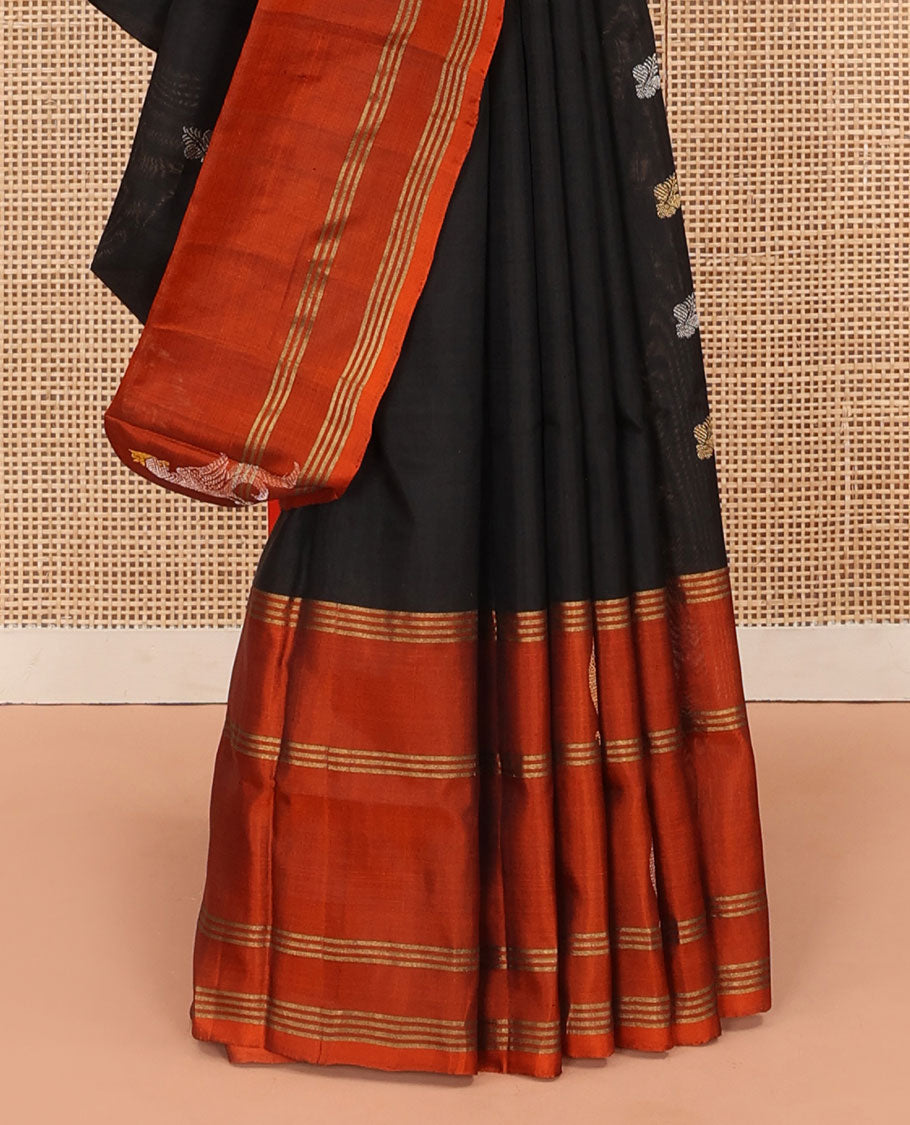Inky Black Uppada Silk Saree Enlivened With Zari Buttas, Captivating Contrast Border Featuring Zari Stripes And Peacock Motifs, Pallu Depicting Rose Flower-Enclosed Mughal-Style Arches, And Paired With A Contrast Blouse