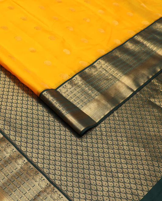 Yellow manga buttas Vasundhara silk mix saree, contrast geometric patterned zari border, and leaf motifs steeped pallu