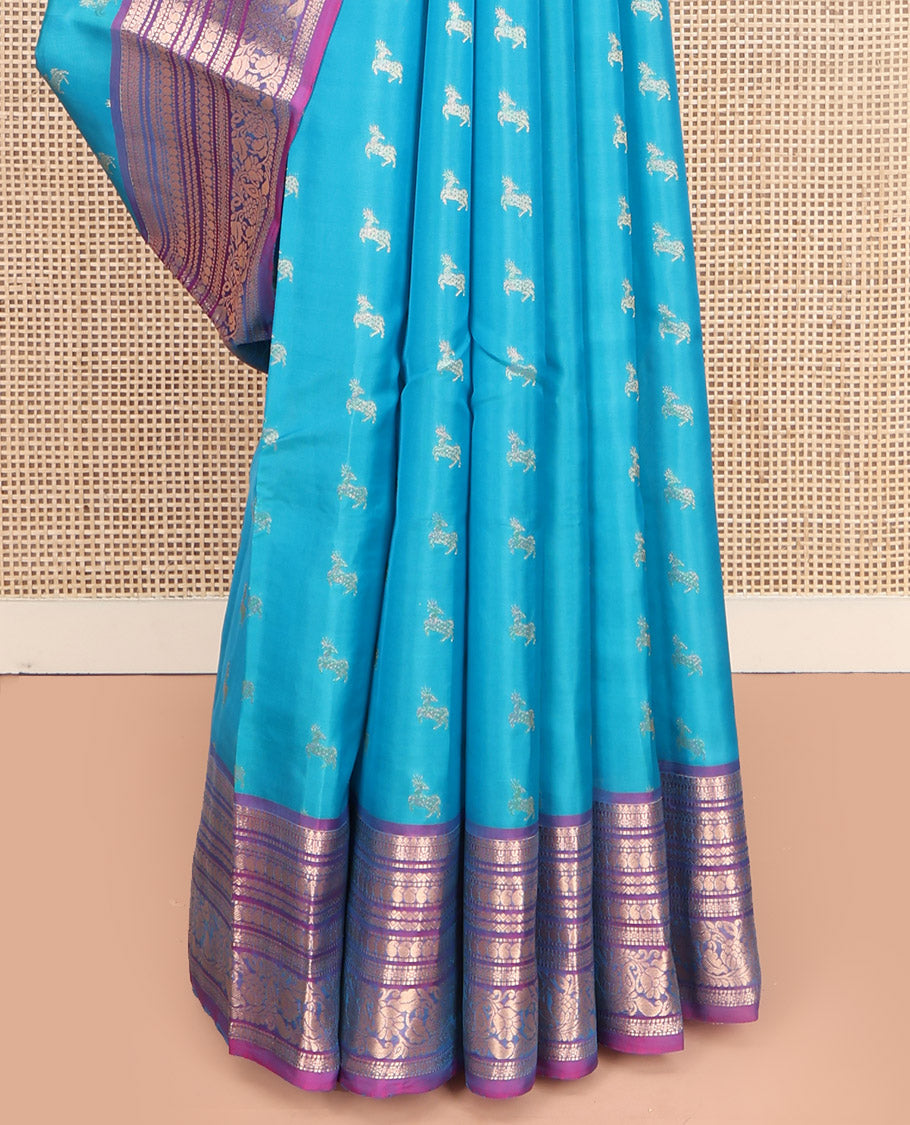 Blue Vasundhara Lite-Silk Mix Saree, Featuring Deer Buttas All Over Its Body, Complemented by a Contrast Border of Thilakam Mokku, Muthu, Kamalam, Neli, Manga, and Kodi Visiry Designs, Opulently Embellished Pallu, and Paired with a Contrast Blouse