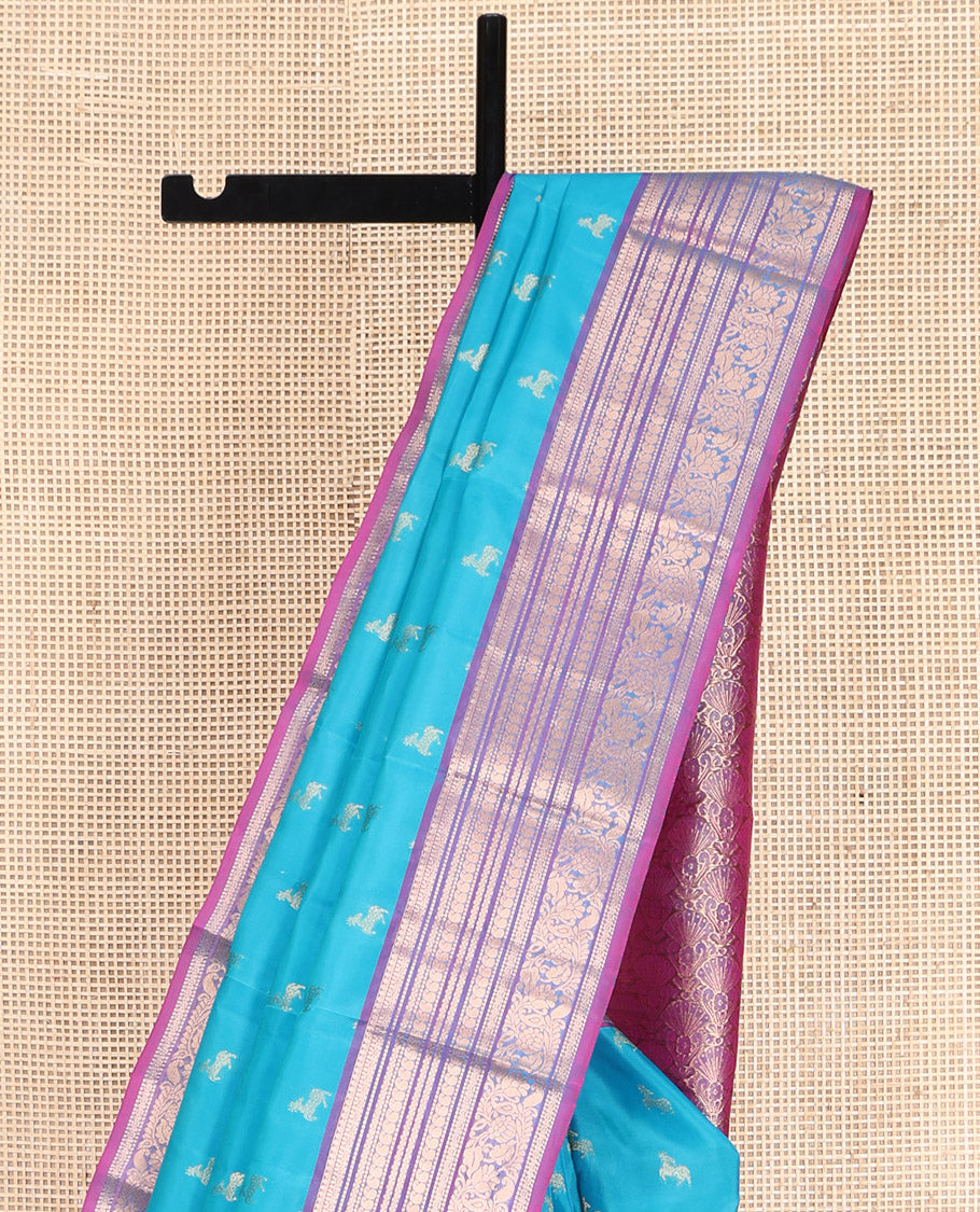 Blue Vasundhara Lite-Silk Mix Saree, Featuring Deer Buttas All Over Its Body, Complemented by a Contrast Border of Thilakam Mokku, Muthu, Kamalam, Neli, Manga, and Kodi Visiry Designs, Opulently Embellished Pallu, and Paired with a Contrast Blouse