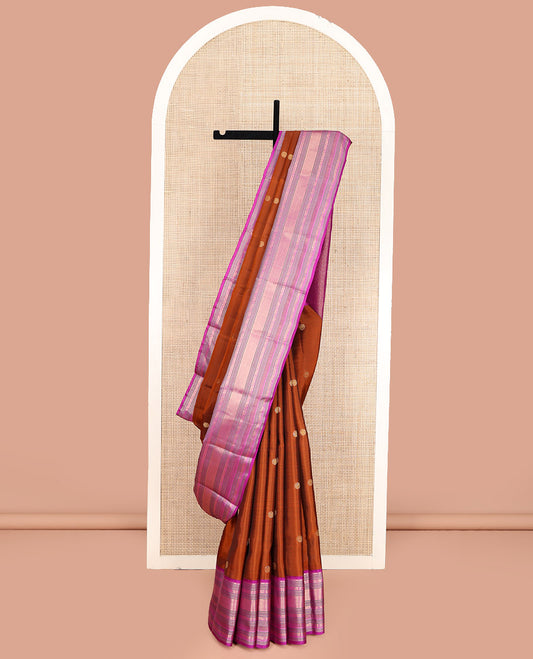 Rust Orange Vasundhara Lite Silk Mix Saree, Showcasing with Zari Buttas, Complemented by a Contrast Border of Thilakam Mokku, Banaras, Mayil, Yaanai, and Mayil Kann Designs, Artfully Detailed Pallu of Jaal Designs, and Paired with a Contrast Blouse