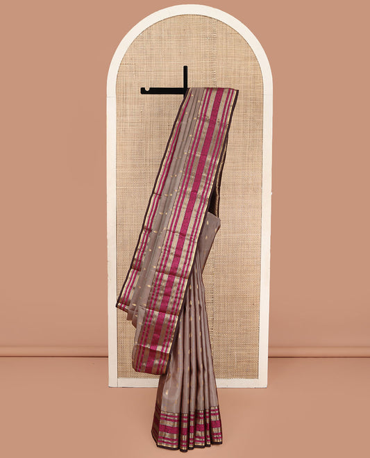 Pale Brown Vasundhara Lite Silk Mix Saree, Accentuated with Zari Buttas on Its Body, Complemented by Contrast Border of Rekku, Muthu, and Kodi Visiry Designs, Grand Pallu Steeped with Poo Chakram Designs, and Paired with a Contrast Blouse