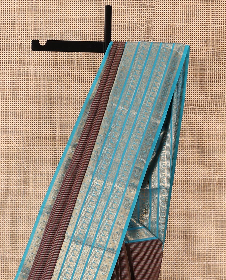 Brown striped Vasundhara silk mix saree, contrast border of muthu, paisa, and mayil designs, and jaal pallu