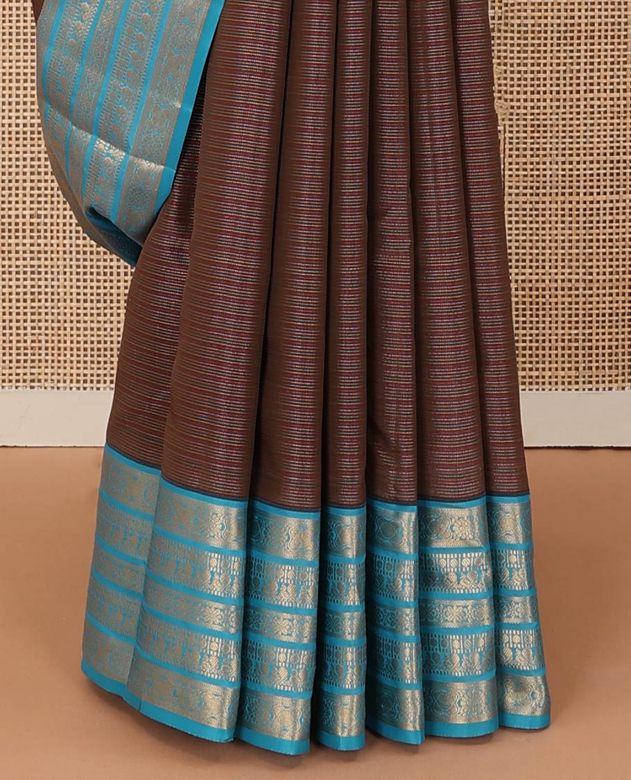 Brown striped Vasundhara silk mix saree, contrast border of muthu, paisa, and mayil designs, and jaal pallu