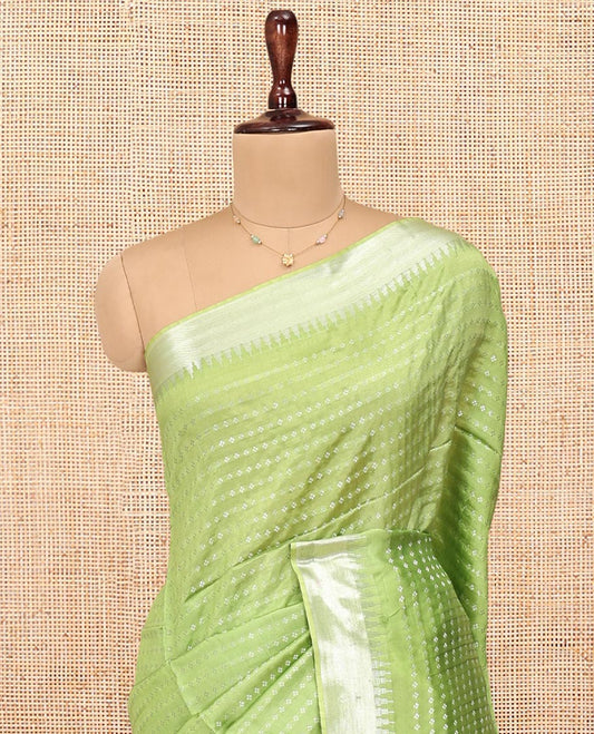 Light Green Banana Pith Saree, Lightly Embellished with Buttas All Over Its Body, Highlighted by a Zari Temple Border, Gleaming Zari Striped Pallu, and Paired with a Matching Blouse