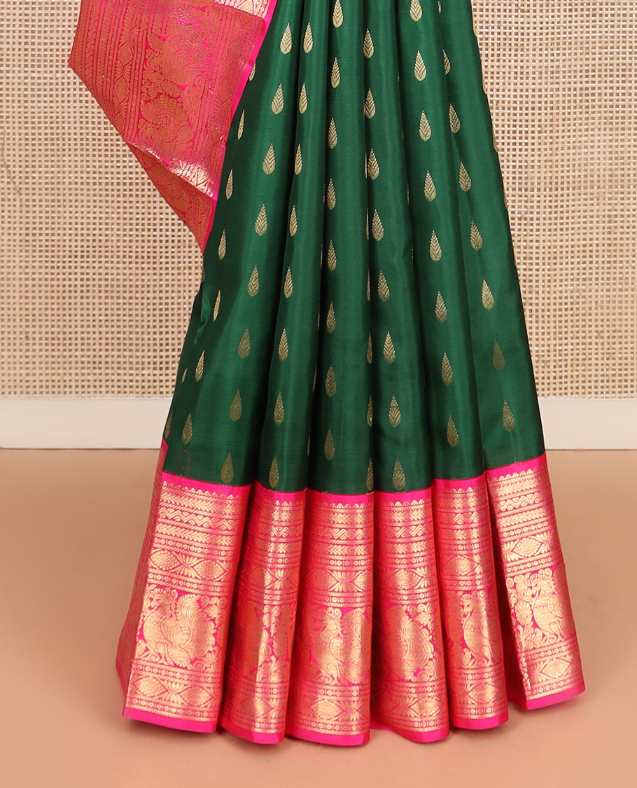 Green thilakam buttas silk saree, contrast border of rekku, muthu, kathir, neli, laddu kamalam, and mayil designs, and jaal pallu