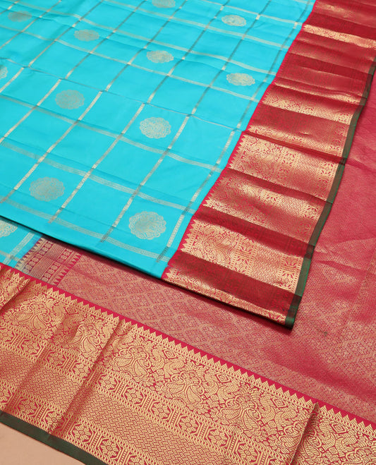 Blue butta enclosed checked silk saree, contrast border of rekku, muthu, manga, mayil, and kamalam designs, and jaal pallu