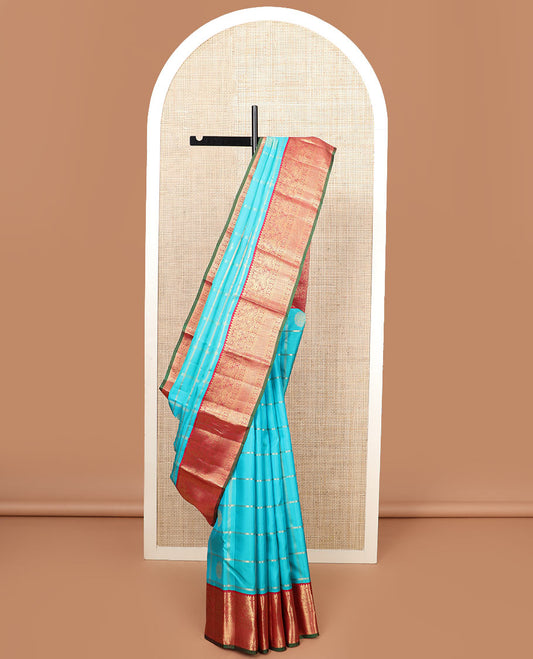 Blue butta enclosed checked silk saree, contrast border of rekku, muthu, manga, mayil, and kamalam designs, and jaal pallu
