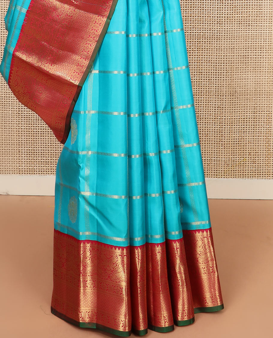 Blue butta enclosed checked silk saree, contrast border of rekku, muthu, manga, mayil, and kamalam designs, and jaal pallu