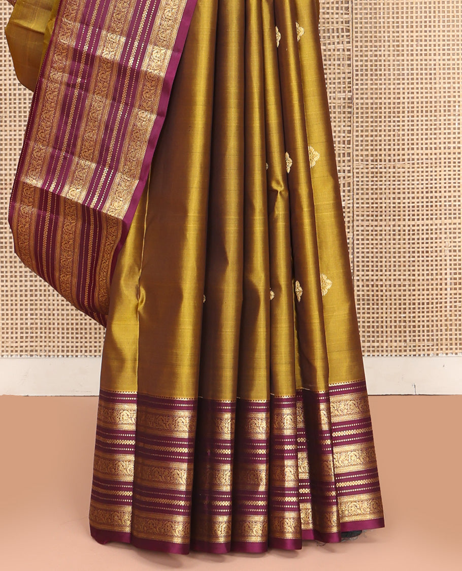 Green Vasundhara Silk Saree, Embellished with Zari Buttas All Over Its Body, Complemented by Contrast Border of Rekku, Muthu, Kathir, And Mayil Designs, Paiyadi Kattam Pallu, and Paired with a Contrast Blouse