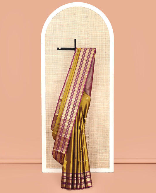 Green Vasundhara Silk Saree, Embellished with Zari Buttas All Over Its Body, Complemented by Contrast Border of Rekku, Muthu, Kathir, And Mayil Designs, Paiyadi Kattam Pallu, and Paired with a Contrast Blouse