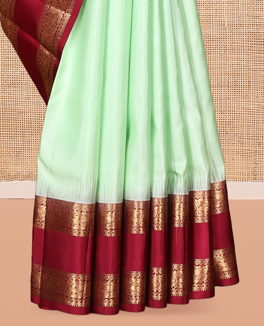 Green Zari Buttas Vasundhara Silk Saree Adorned with a Contrast Rettai Pettu Border of Rekku, Muthu, and Kodi Mayil Designs, Grand Pallu, and a Contrast Blouse