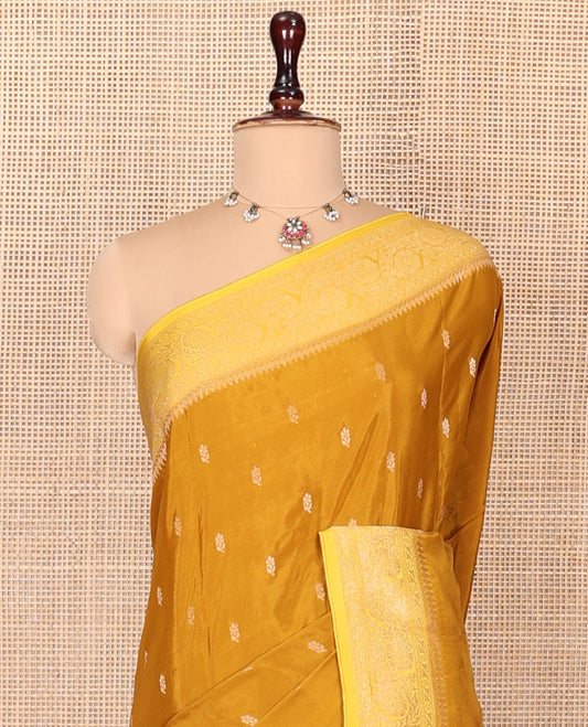 Mustard Fancy Crepe Saree, Adorned with Buttas, Complemented by a Contrast Floral Creeper Border, Intricately Designed Pallu, and a Contrast Blouse