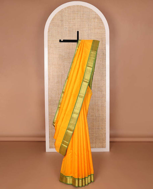 Orange kancheepuram silk saree with contrast thilakam mokku, banaras, ara madam design & striped pallu