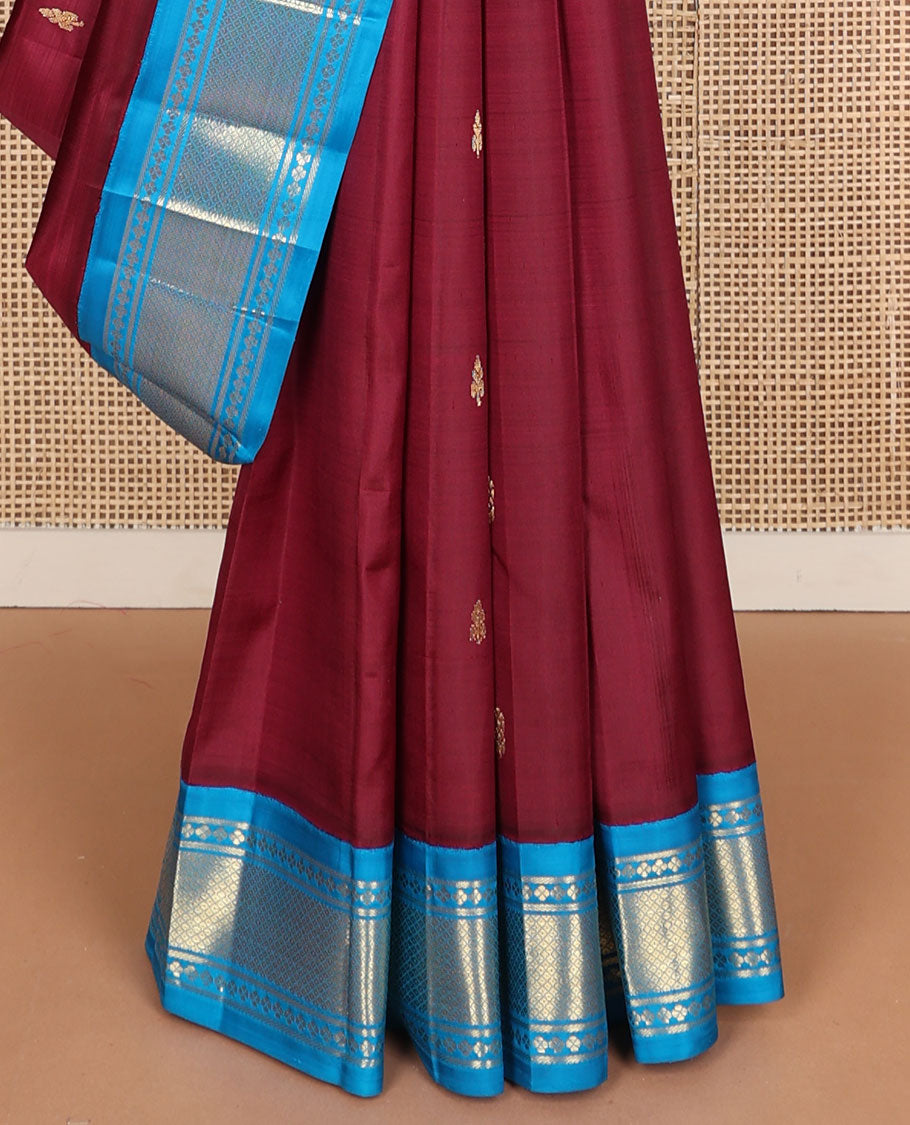 Maroon zari buttas Kanchipuram silk saree, contrast one-sided korvai border of lavangam, and mayil kann designs, and zari design pallu