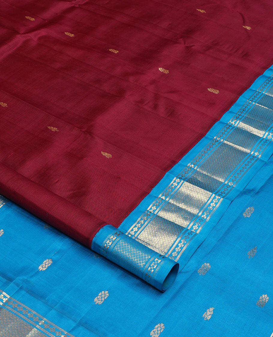 Maroon zari buttas Kanchipuram silk saree, contrast one-sided korvai border of lavangam, and mayil kann designs, and zari design pallu