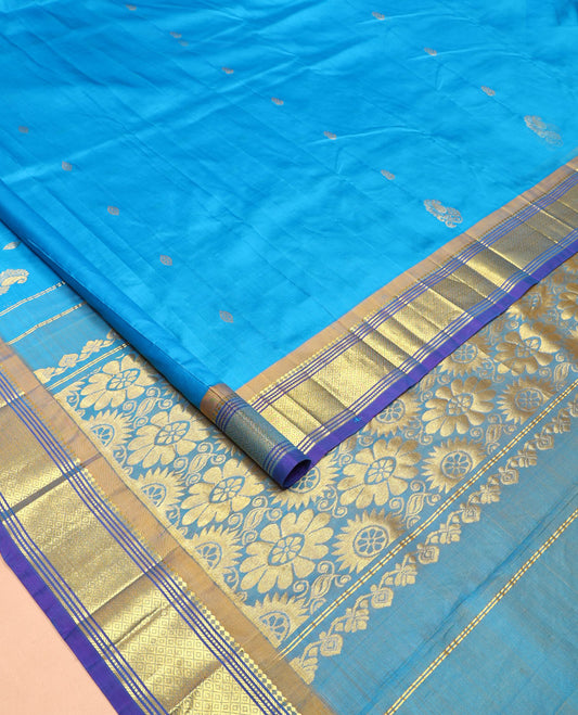 Blue Kanchipuram Silk Saree, Highlighted with Zari Buttas All Over Its Body, Complemented by a Contrast One-Sided Border of Panner Sombu, Banaras, Muthu, and Mayil Kann Designs, Pallu of Floral Designs, and Comes Without a Blouse